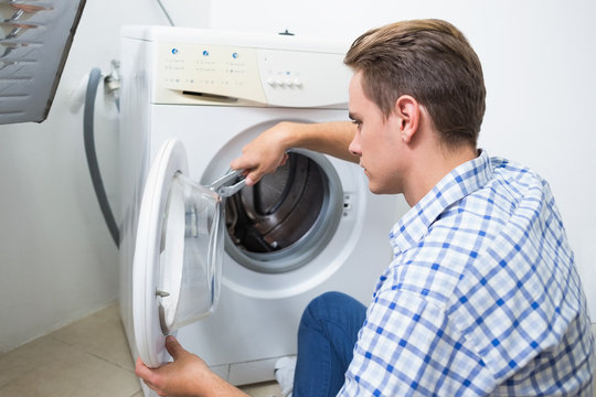 Technician repairing a washing machine