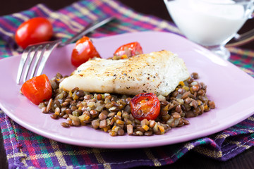 White fish fillet of perch, cod with vegetables, lentils, tomato