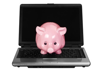 Close-up of a piggy bank on a laptop