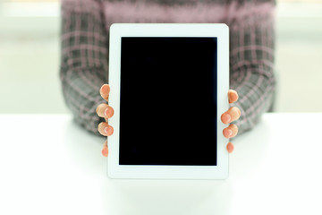 Closeup image of male hands showing display of tablet computer