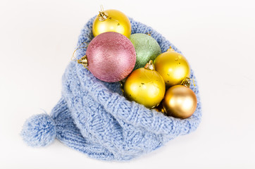 Christmas balls in blue knitted hat