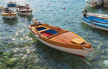 Wooden fishing boats float moored in Adriatic sea