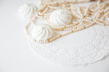Obraz na płótnie Canvas Wedding background with meringue cake and beads