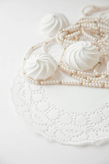 Wedding background with meringue cake and beads