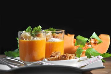 two glasses with pumpkin soup and bread