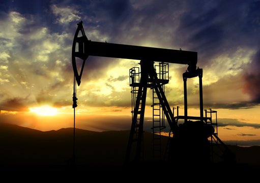 Oil pump on sunset background