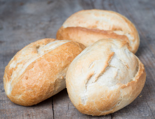 Rolls on the background of the wooden table 