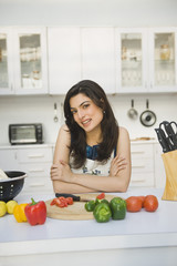 Portrait of a woman leaning on a kitchen counter