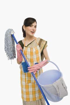 Woman holding a mop and a bucket