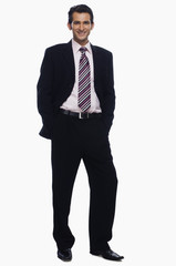 Portrait of a businessman standing with his hands in pockets