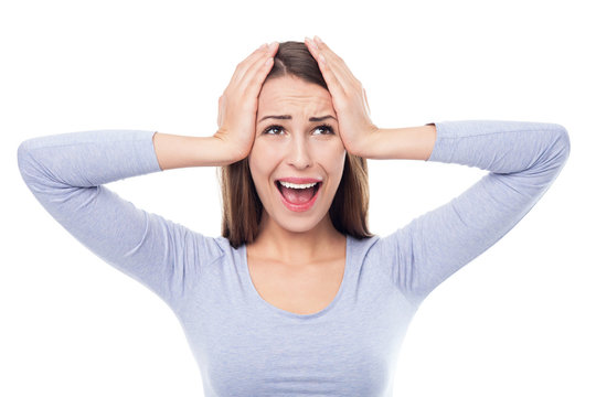 Woman looking surprised with her head in her hands