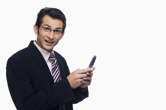 Portrait of a businessman looking surprised while text messaging