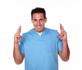 Fototapeta premium Gorgeous male nurse crossing his fingers
