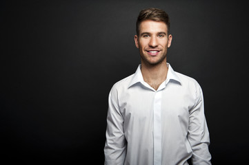 Obraz premium Portrait of a young handsome man a white shirt