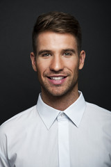 Portrait of a young handsome man a white shirt