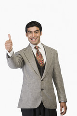 Businessman showing thumbs up