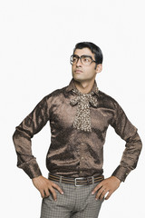 Businessman standing with arms akimbo