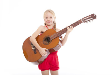 young happy girl standing with guitar