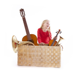 young girl with musical instruments in box