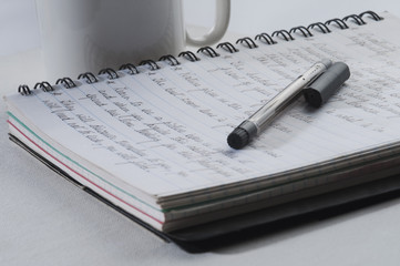 Close-up of a pen on an open notebook