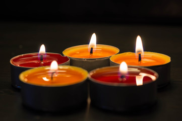 Obraz na płótnie Canvas Five burning candles against a dark background