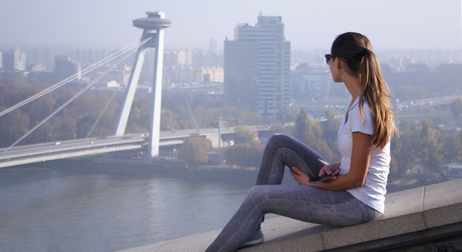 girl sitting over Bratislava