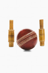 Close-up of a cricket ball and bails