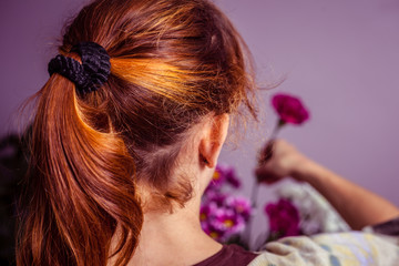 Fototapeta premium Young woman arranging a bouquet of flowers