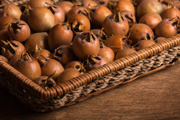 Medlar Fruits in Tray on Wooden Board