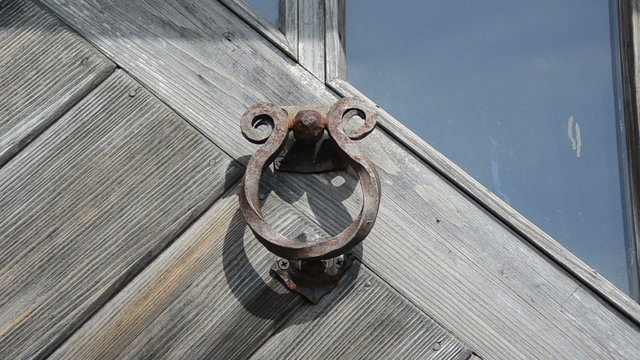 guest hand knock retro rusty door handle used as buzzer ringer