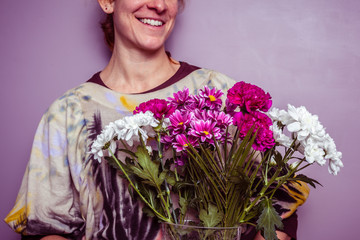 Happy young woman with bouquet of fresh flowers