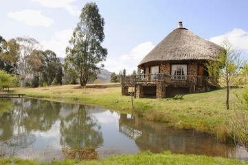 Fototapeta na wymiar Quaint thatch and stone holliday cottage,Underberg,kwazulu Natal