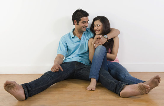 Couple sitting on the floor and smiling