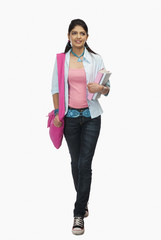 Female university student holding books