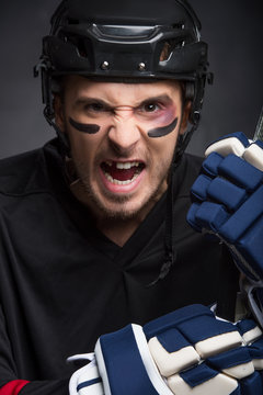 Portrait of hockey player with screaming angry look.