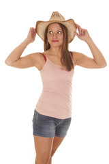 Woman cowgirl hat hold sides look side
