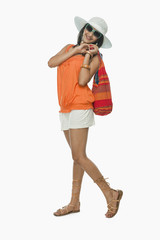 Woman carrying a bag and smiling