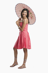 Woman holding a parasol and smiling © imagedb.com
