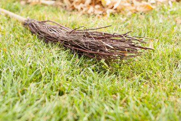 Autumn clearing - besom and a pile of leaves
