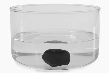 Close-up of a stone sunk in a bowl of water