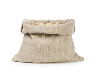 Fototapeta na wymiar roasted salty pistachios nuts in sack bag