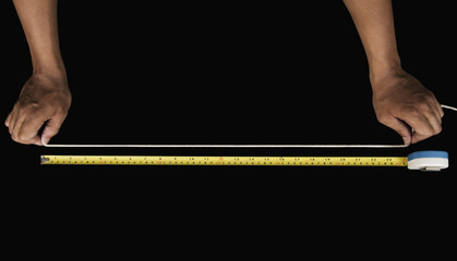 Close-up of a man measuring string with a tape measure