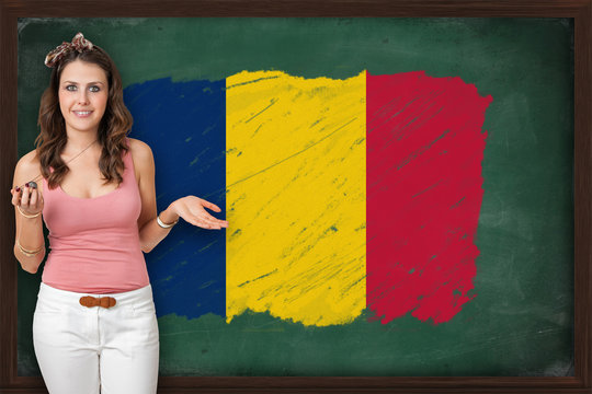 Beautiful And Smiling Woman Showing Flag Of Chad On Blackboard