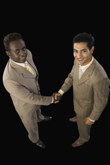 High angle view of two businessmen shaking hands