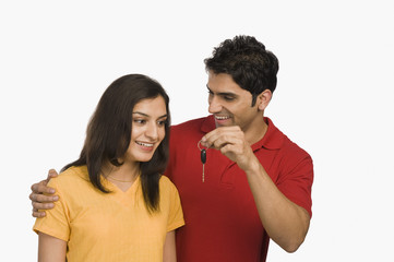 Man giving a car key to woman