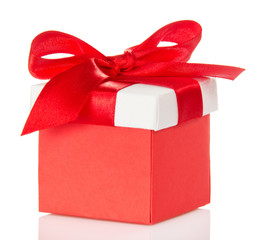 Red gift box and bright cover with bow