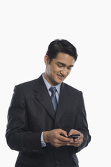 Businessman text messaging on a mobile phone
