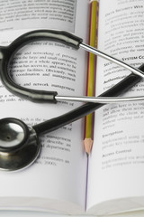 Close-up of a stethoscope on an open book