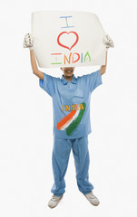 Fototapeta na wymiar Woman in cricket uniform holding a placard with text I Love India written on it