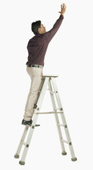 Businessman on a ladder © imagedb.com